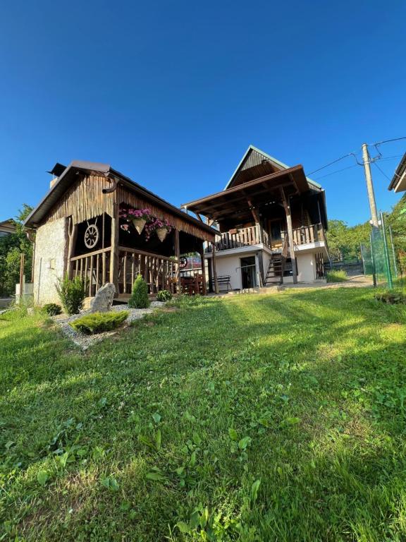 a large building with a grass field in front of it at Chatka Helenka in Krpacovo