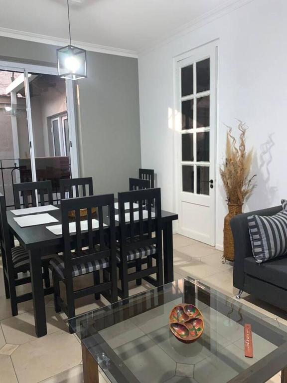 a living room with a table and chairs and a couch at Casona centrica alameda Mendoza in Mendoza