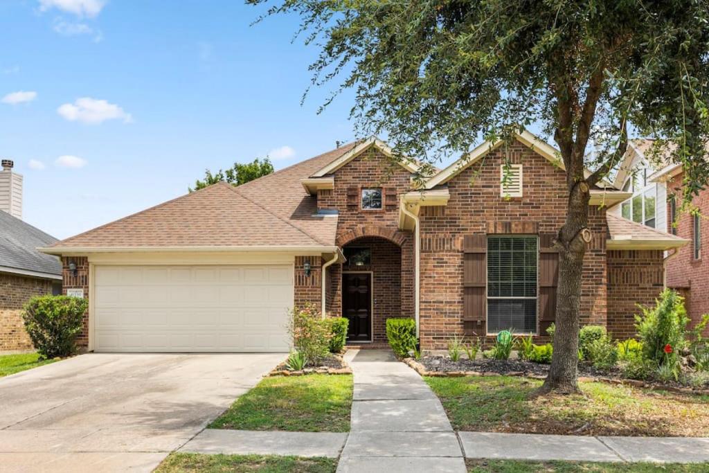 a brick house with a garage at Parkside Serenity Bear Creek and Sam Race Track in Houston