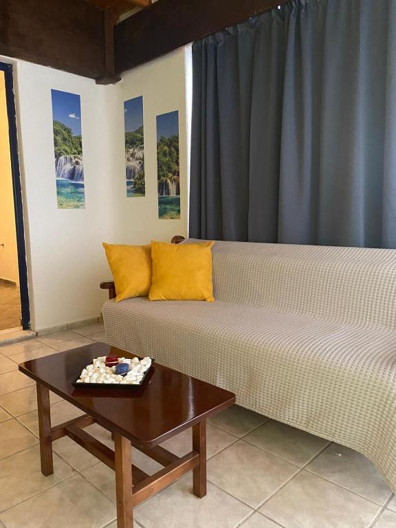 a living room with a couch and a coffee table at Yellow Beach House in Logaras
