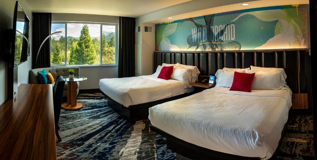 a hotel room with two beds and a large window at Seven Feathers Casino Resort in Canyonville