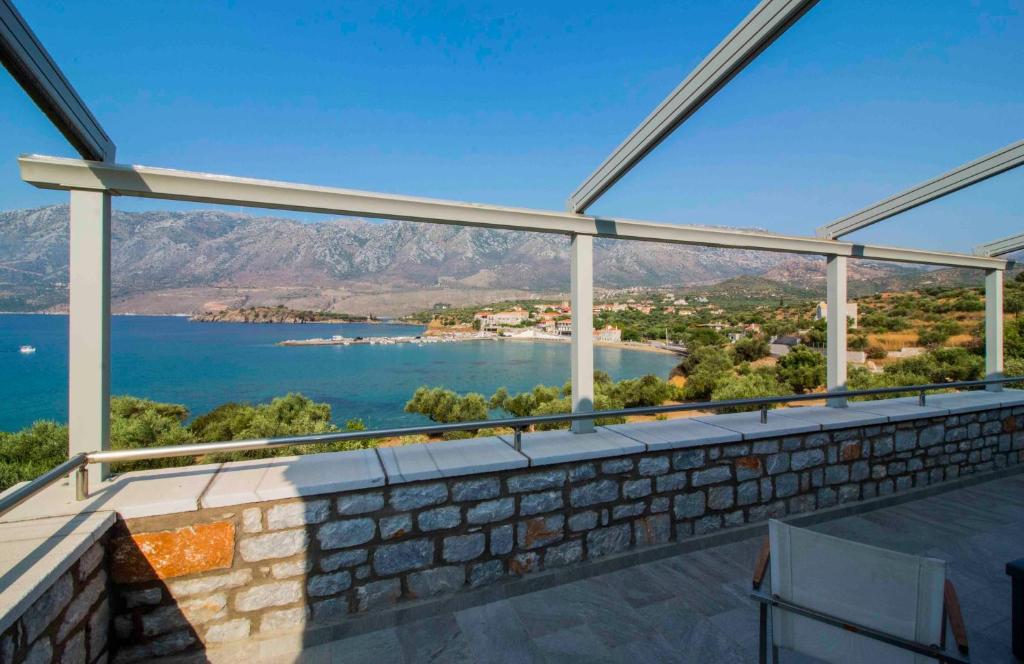 a view of the water from the balcony of a house at Laconian Collection Kotronas Residence in Kotronas