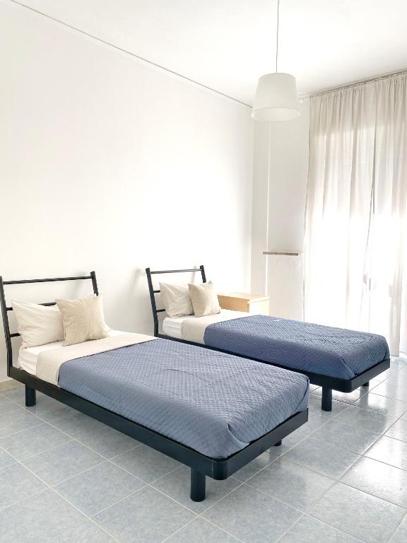 Postel nebo postele na pokoji v ubytování NERI Rooms