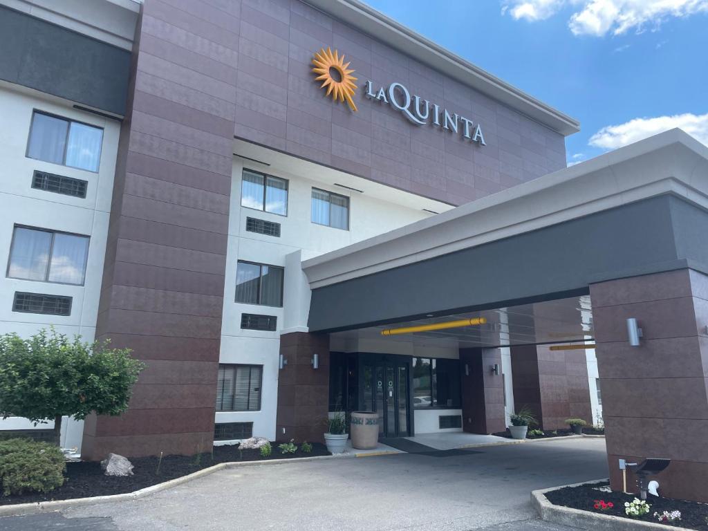 a building with a sun sign on the front of it at La Quinta Inn by Wyndham Cincinnati North in Springdale