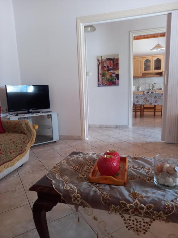 a living room with a table with an apple on it at Εξοχική κατοικία Αnna's house 