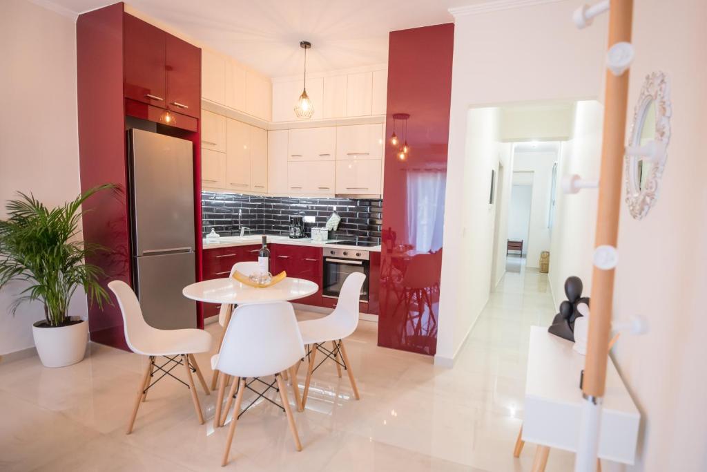 a kitchen with a table and chairs in a room at Vonitsa Luxury Apartments in Vonitsa