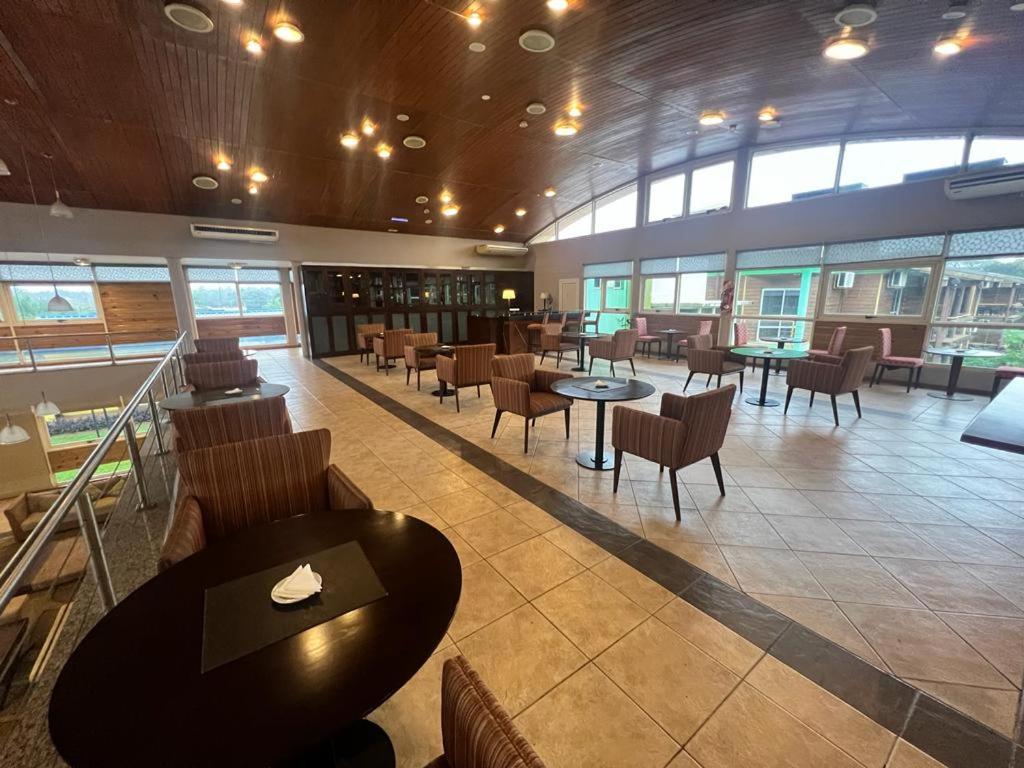 a restaurant with tables and chairs in a building at Hotel Maitei Posadas in Posadas