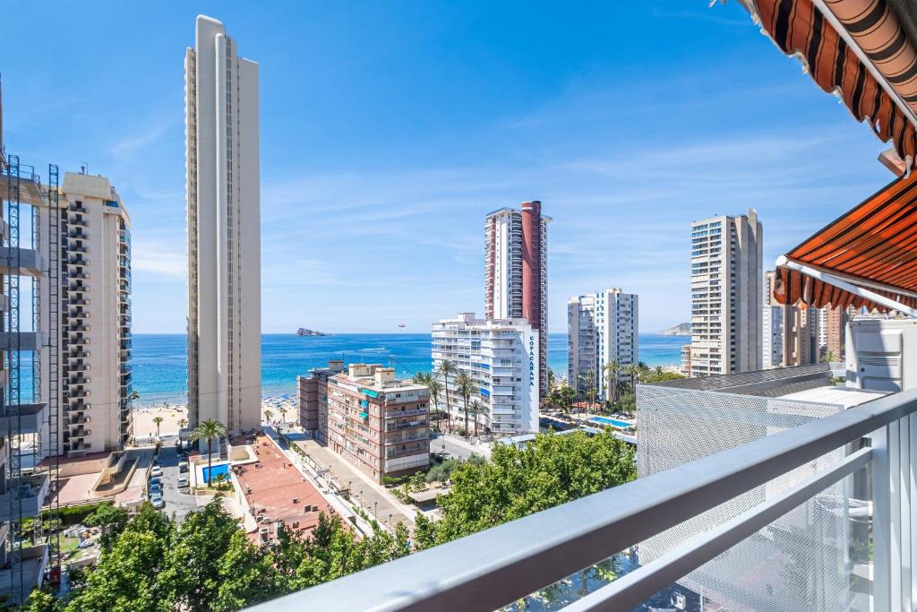 a balcony with a view of the ocean and buildings at Ducado 10-J Apartment Levante Beach in Benidorm