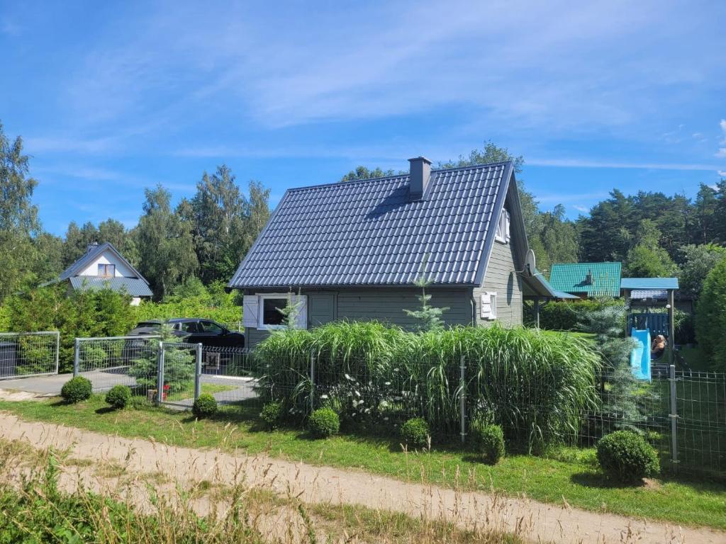 a house with a solar roof in a yard at Kajetanówka in Jackowo