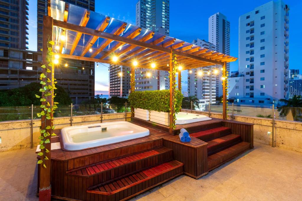 a bathroom with a tub and a gazebo at GIO hotel Tama Cartagena in Cartagena de Indias