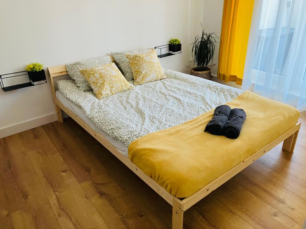 a bed with two pairs of shoes sitting on it at Apartament na Klasztornej in Wągrowiec
