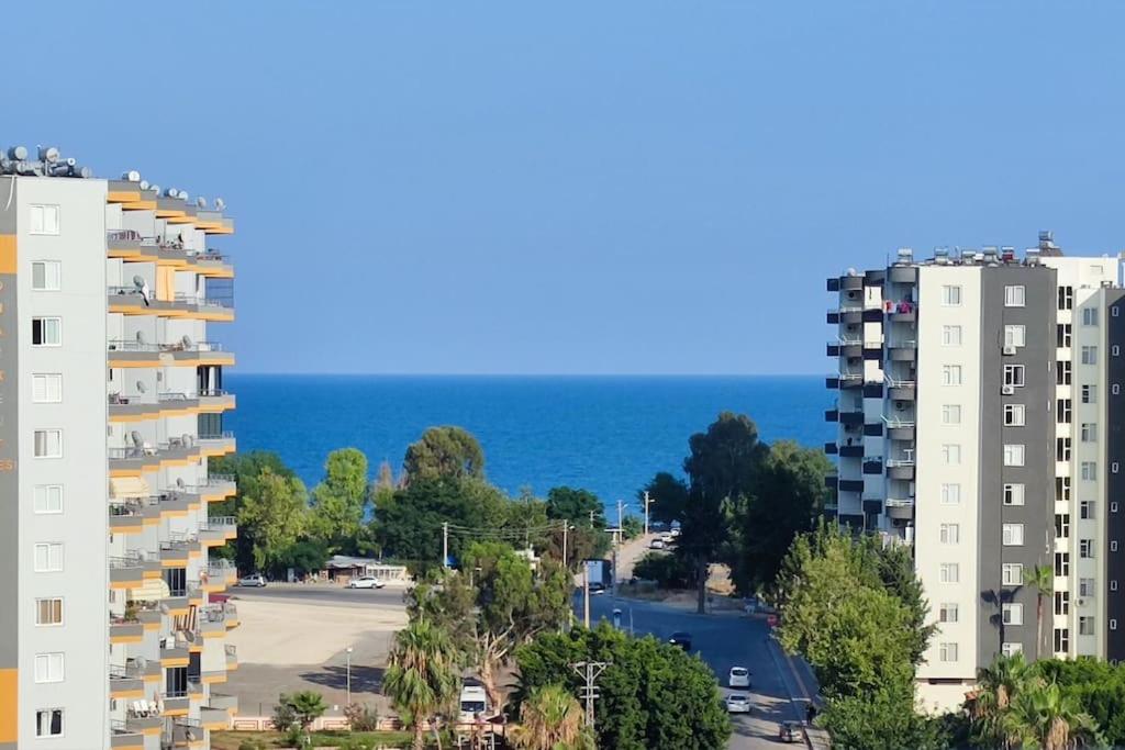 a view of two tall buildings and the ocean at Прекрасный вид на море in Mezitli
