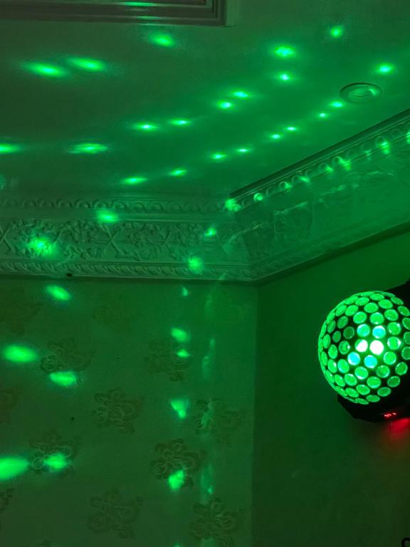 a green ceiling with a disco ball and green lights at استراحة زين in Al Madinah