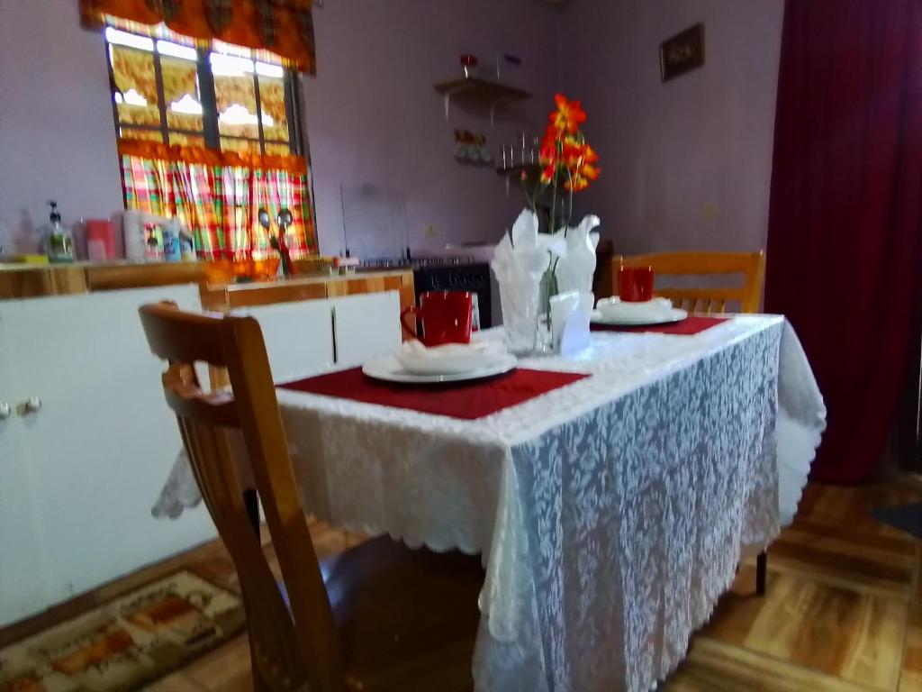a table in a kitchen with a white table cloth at palms in Jerningham Junction