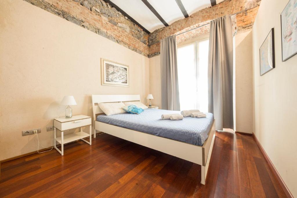 Loft Galata في جينوا: غرفة نوم بسرير ونافذة