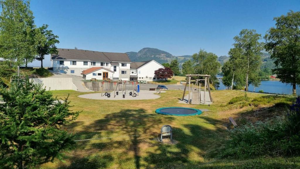 einen Park mit Spielplatz neben einem See in der Unterkunft Pulpit Rock Hostel Vaulali in Tau