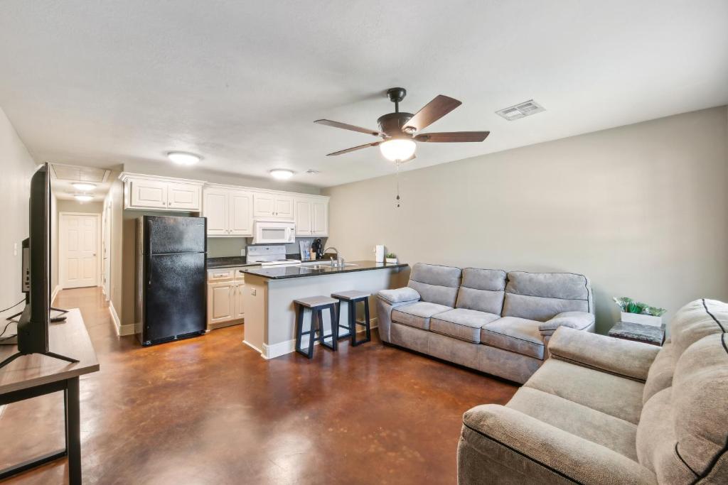 a living room with a couch and a kitchen at Lovely Lake Charles Duplex in Central Location! in Lake Charles