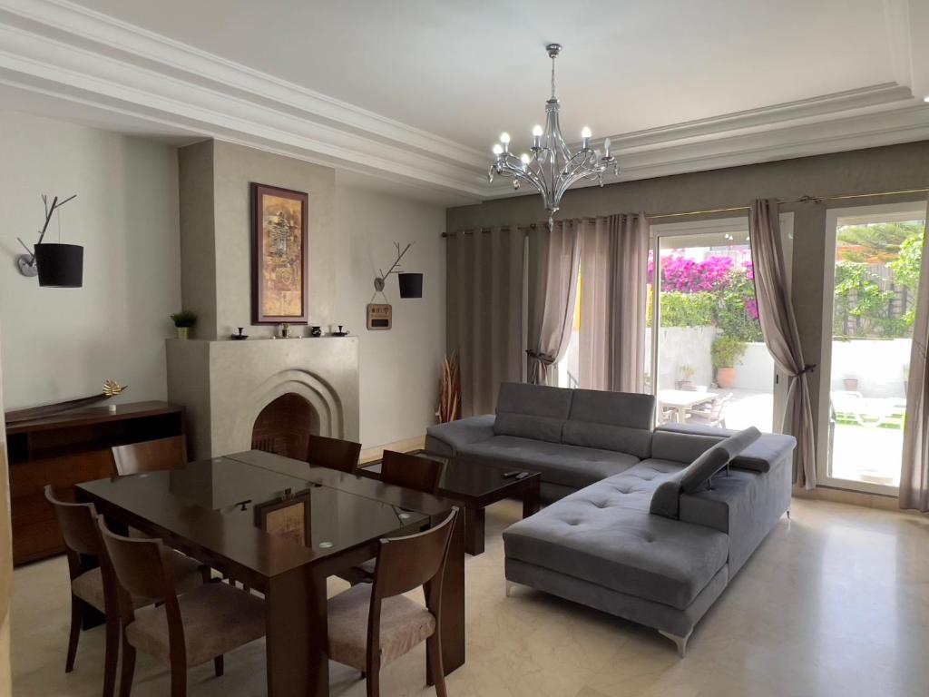 a living room with a couch and a table at Les jardins Malabata in Tangier