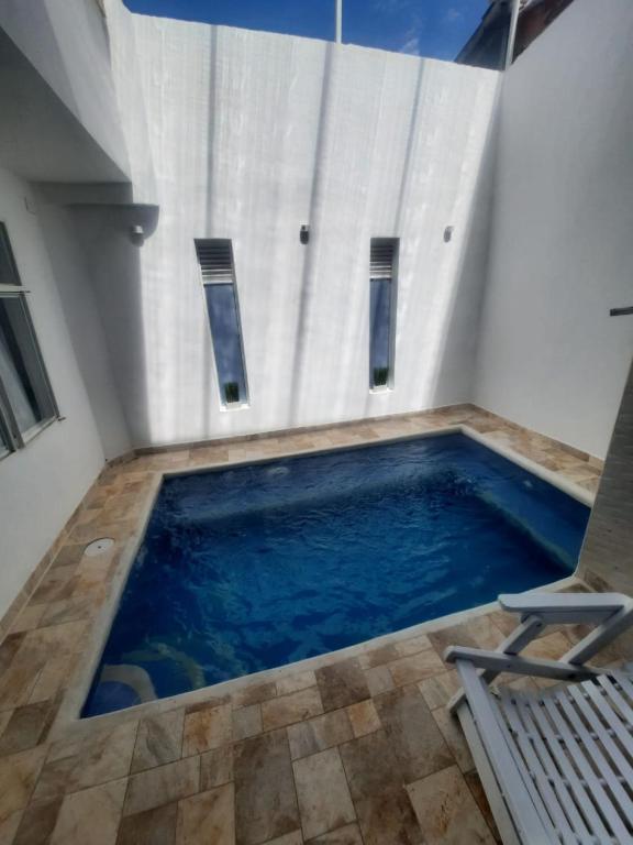 a swimming pool in a room with a chair at CASA VACACIONAL Babilonia in Girardot