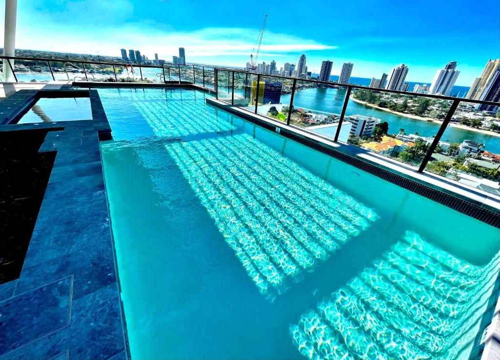 a swimming pool on the roof of a building with a city skyline at Ollies Place in Gold Coast