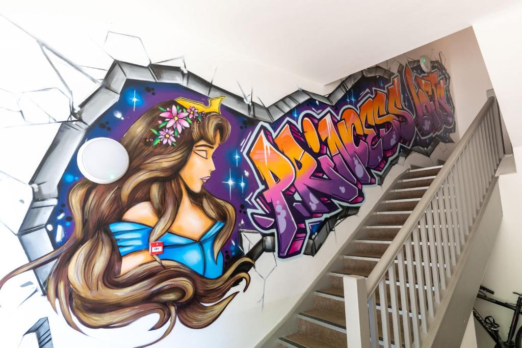 a wall mural of a woman in a bikini at Princess Lofts City Centre Studios with Nespresso Coffee Machines By StayRight in Swansea