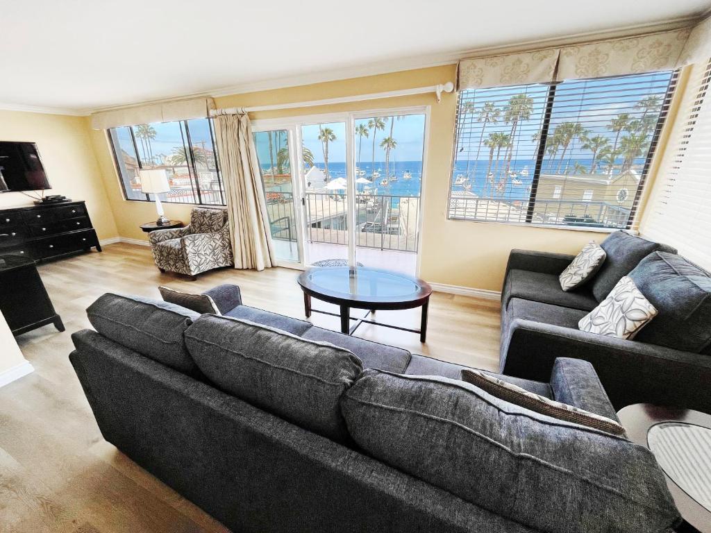 a living room with a couch and a table at Catalina Courtyard Suites in Avalon