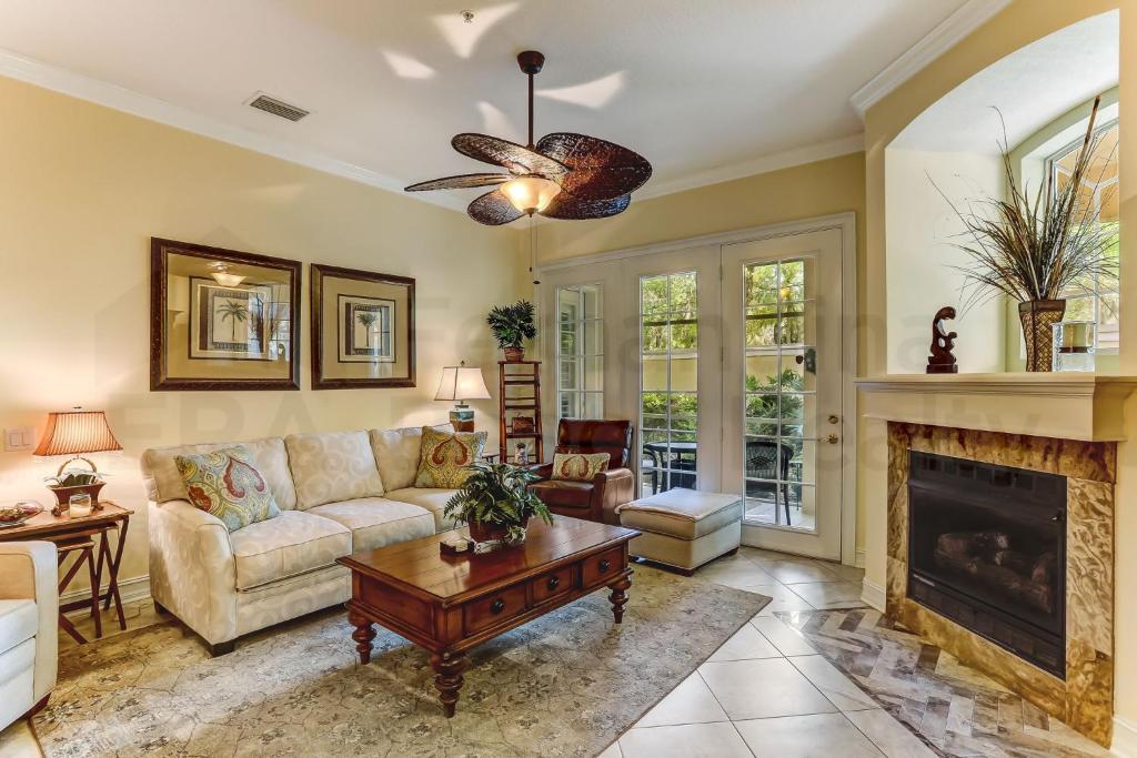 a living room with a couch and a fireplace at Gated Villas at Summer Beach in Amelia Island