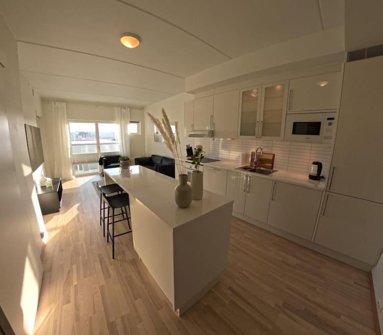 a large white kitchen with a island in a room at Apartment in city center in Alta