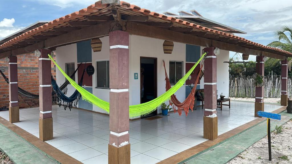 a house with a hammock in front of it at EnjoyMaranhão Santo Amaro in Santo Amaro