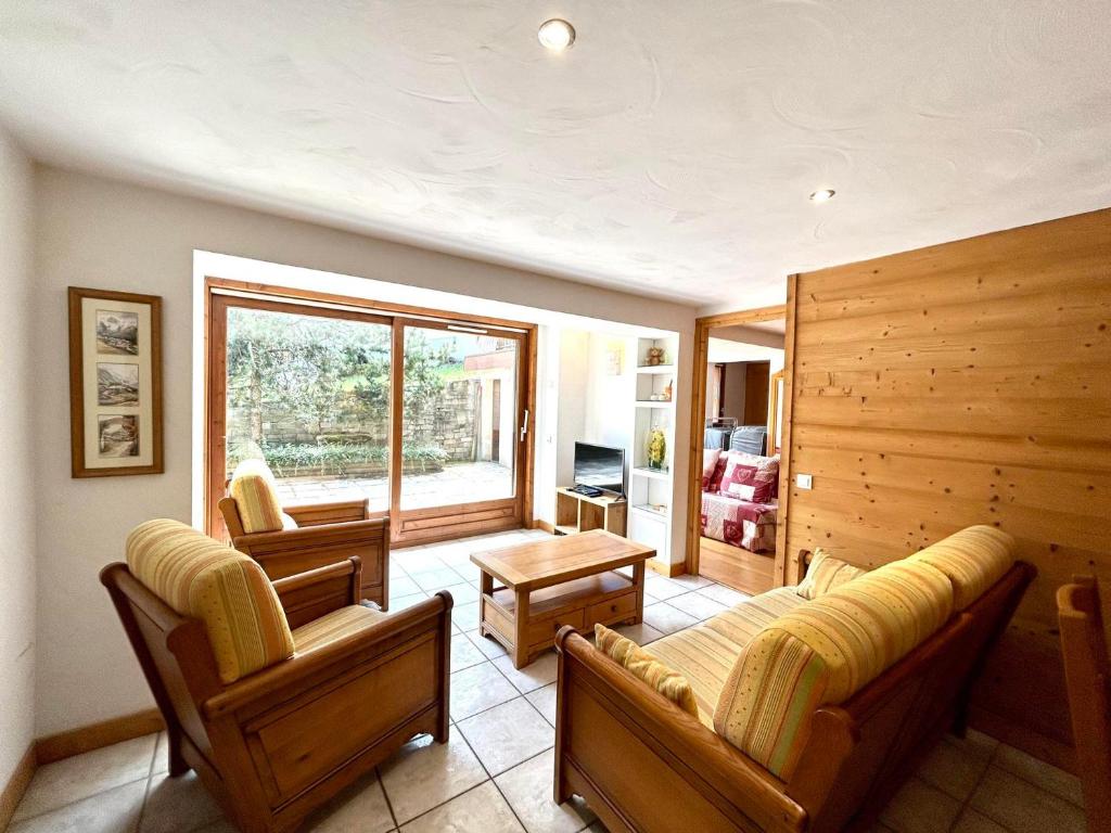 a living room with two couches and a table at Appartement La Clusaz, 4 pièces, 8 personnes - FR-1-437-104 in La Clusaz