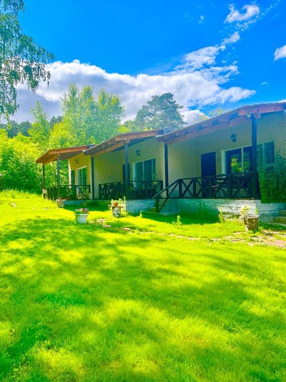 a house with a grass yard in front of it at Private in Shchūchīnsk