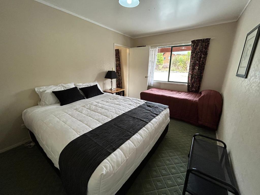 Postel nebo postele na pokoji v ubytování Kiwi Park Motels