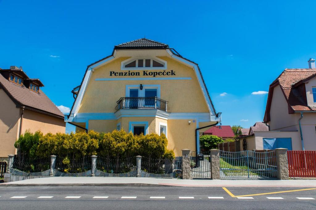 a building with a sign on the side of it at Penzion SLUNCE in Česká Lípa