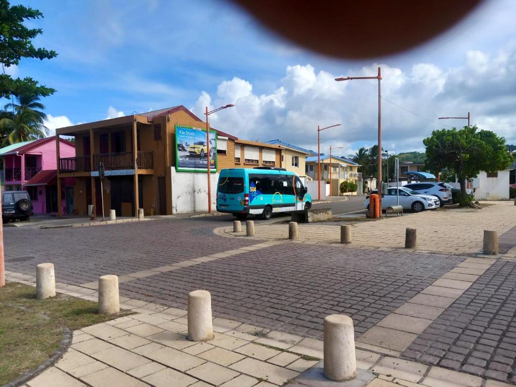 a blue van is parked in a parking lot at Appartement d&#39;une chambre avec balcon et wifi a Le Vauclin a 3 km de la plage in Le Vauclin