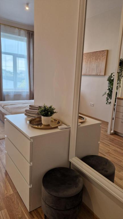 a dressing room with a mirror and two stools at ATF Apartments in Rīga