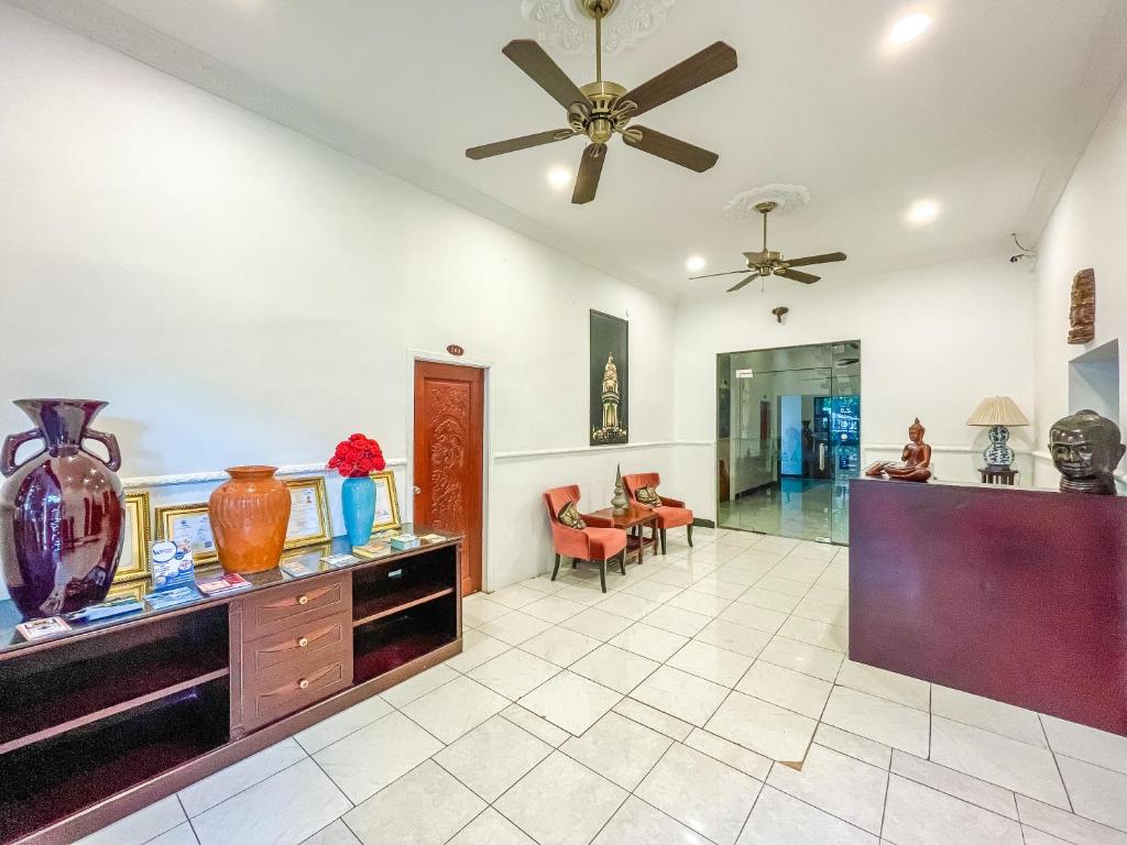 a large living room with a ceiling fan at Birdcage Boutique in Phnom Penh