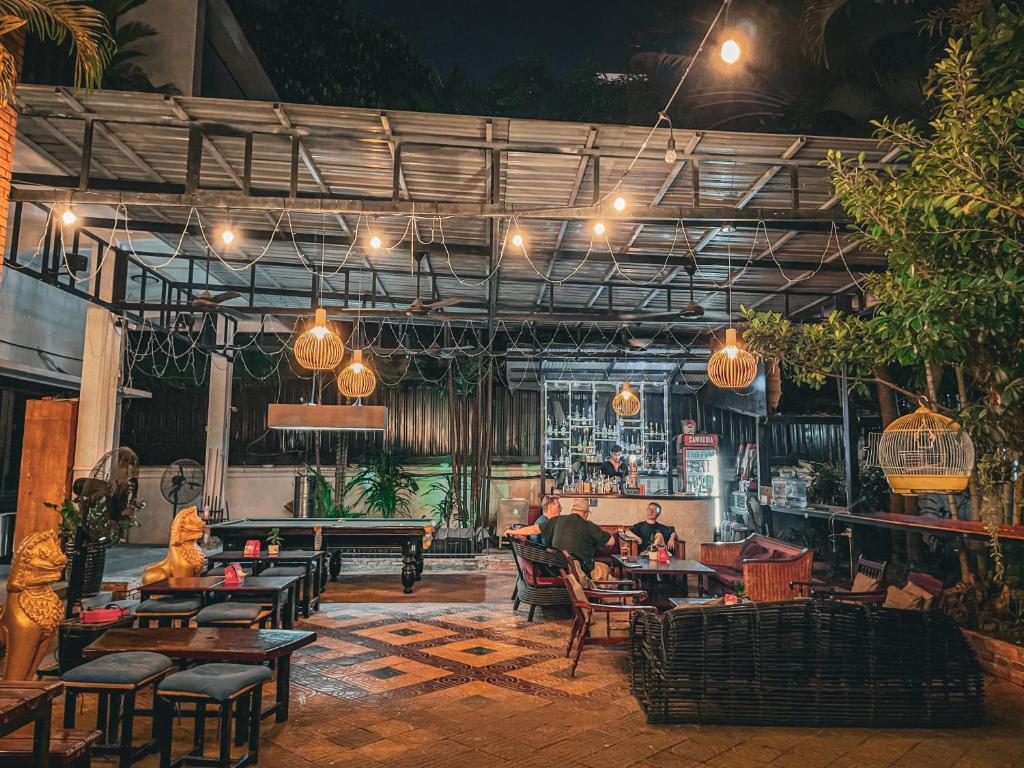 a restaurant with tables and people sitting at tables at Birdcage Boutique in Phnom Penh