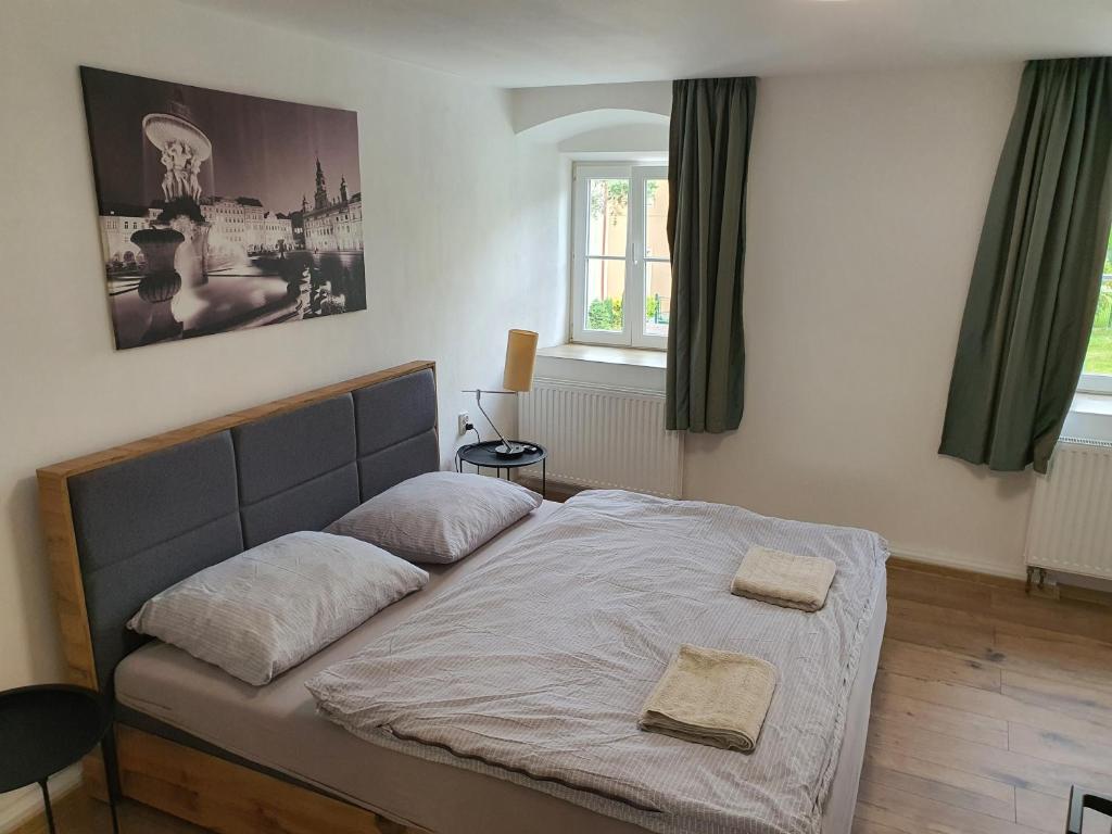 Postel nebo postele na pokoji v ubytování Apartmány ČERNÝ KOHOUT