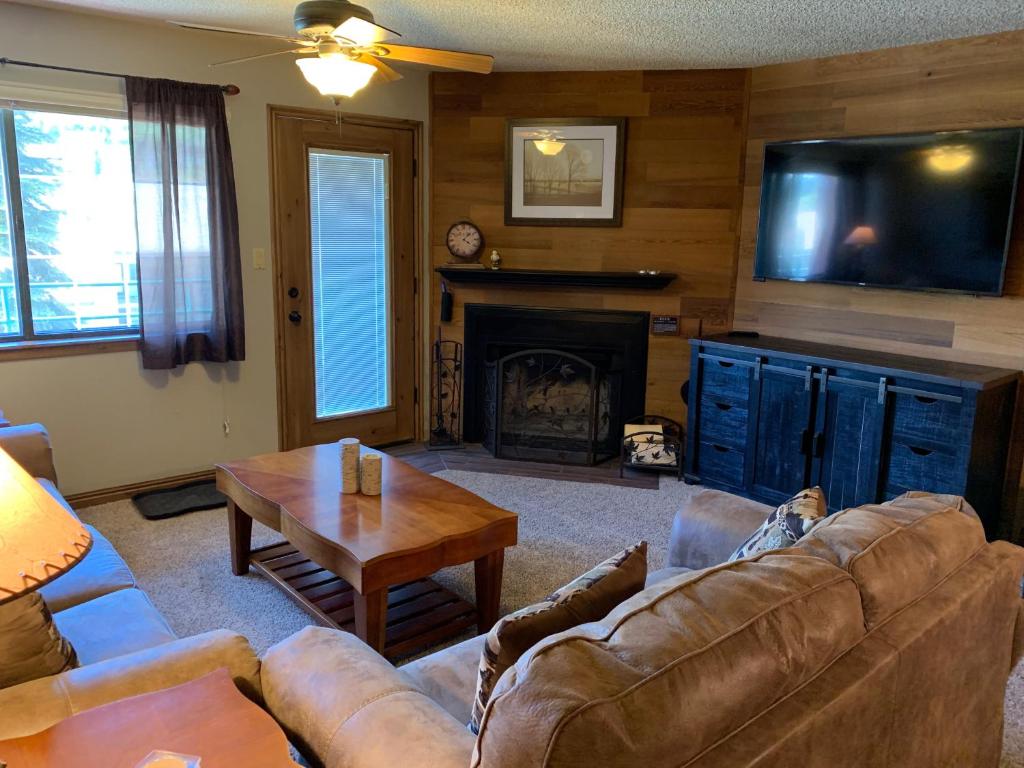 a living room with a couch and a fireplace at Giant Steps 17 Ski In-out in Brian Head