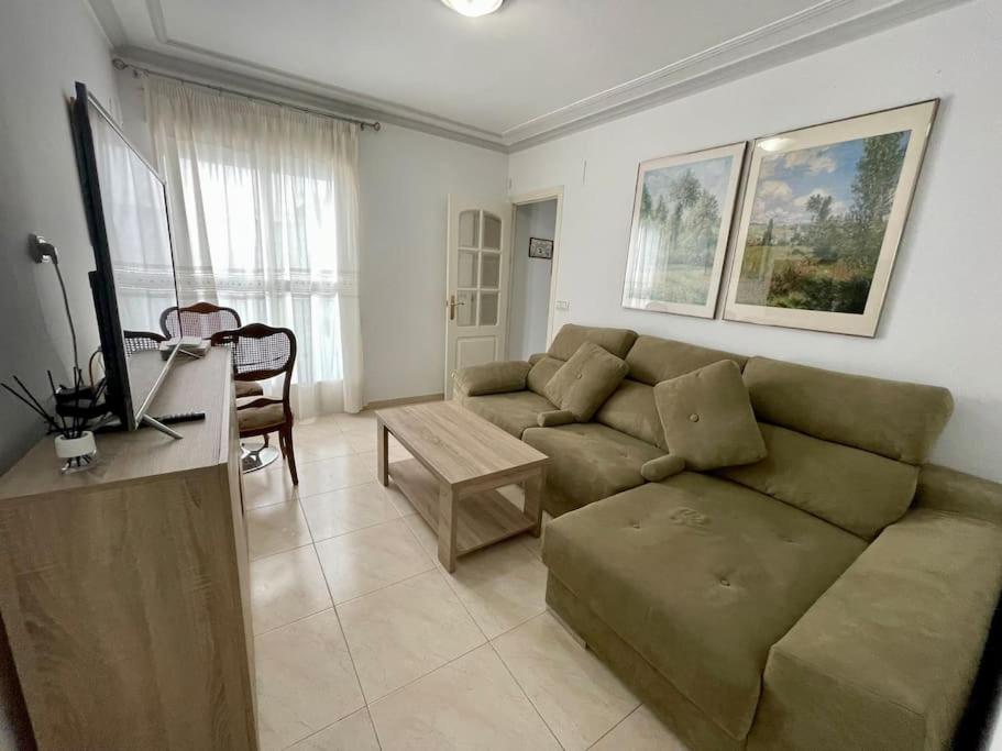 a living room with a couch and a table at Apartamento Alderetes in Córdoba