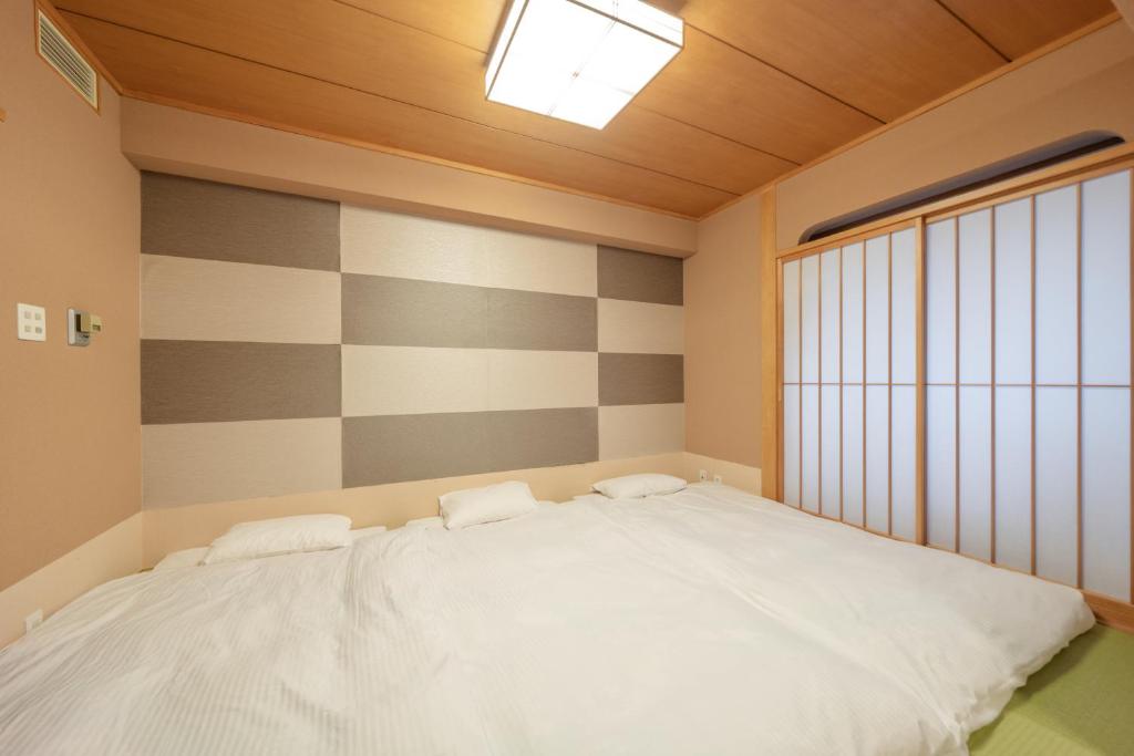 Tempat tidur dalam kamar di New Otani Inn Sapporo
