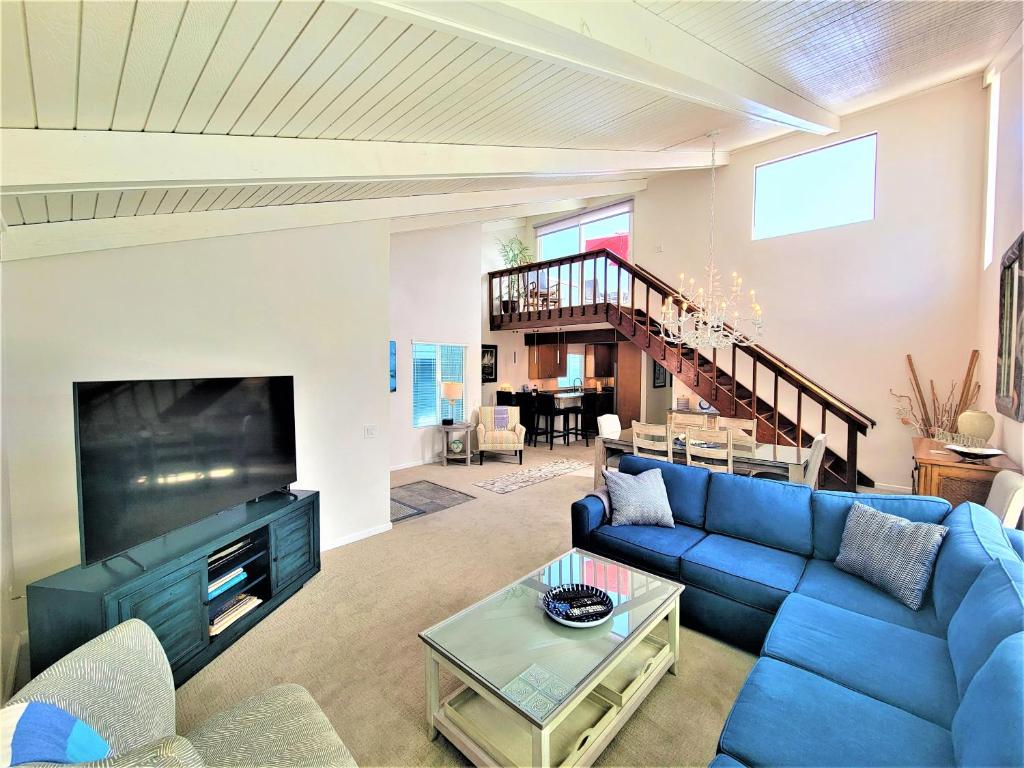 a living room with a blue couch and a fireplace at Luv Oceanside-1 House to Beach in San Diego