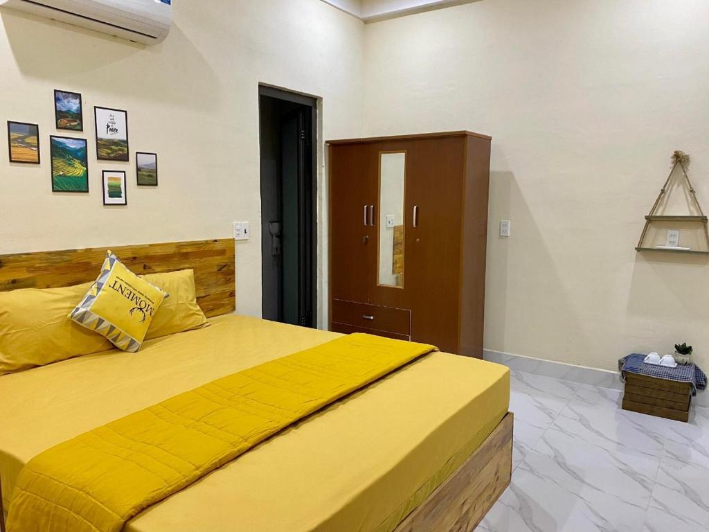 sypialnia z dużym żółtym łóżkiem w pokoju w obiekcie Nhật Lệ Oyster House w mieście Dong Hoi