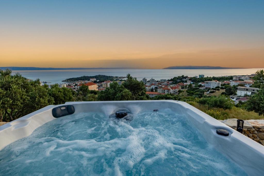 a hot tub with a view of the ocean at Tiny house Aria in Makarska