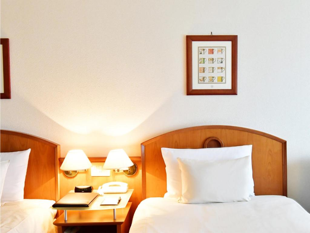 Postel nebo postele na pokoji v ubytování Hotel BELLMARE ホテルベルマーレ