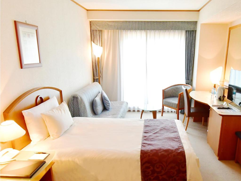 Postel nebo postele na pokoji v ubytování Hotel BELLMARE ホテルベルマーレ