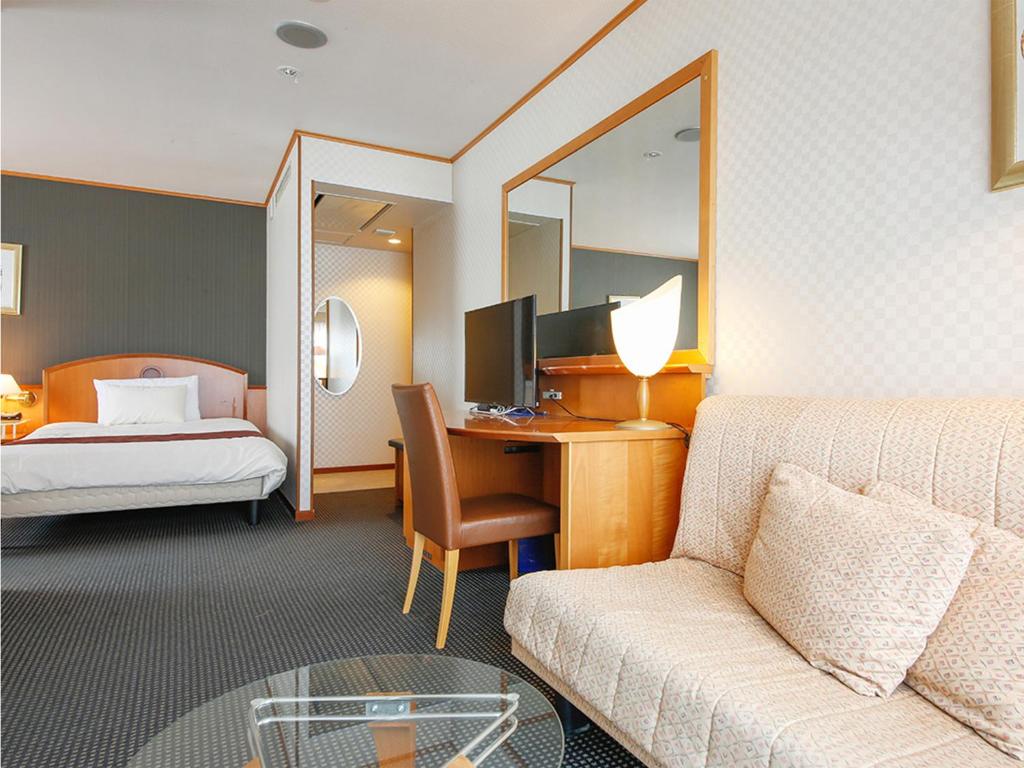 Postel nebo postele na pokoji v ubytování Hotel BELLMARE ホテルベルマーレ