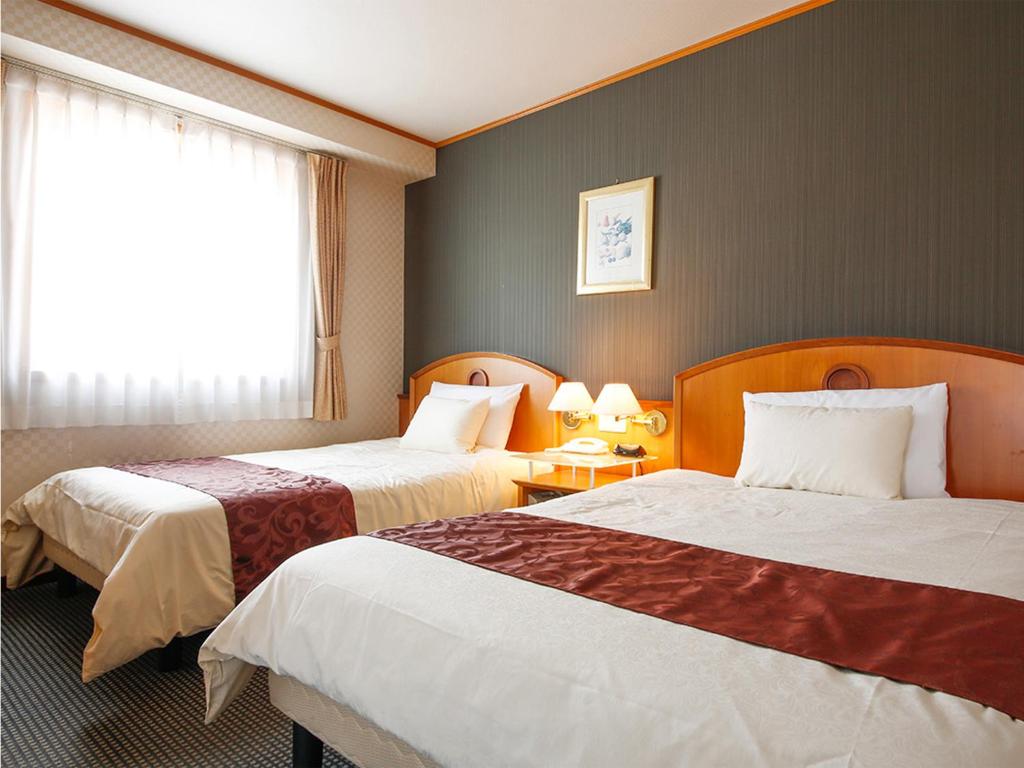 Postel nebo postele na pokoji v ubytování Hotel BELLMARE ホテルベルマーレ