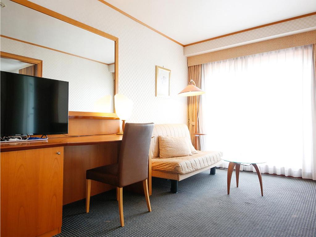 TV a/nebo společenská místnost v ubytování Hotel BELLMARE ホテルベルマーレ