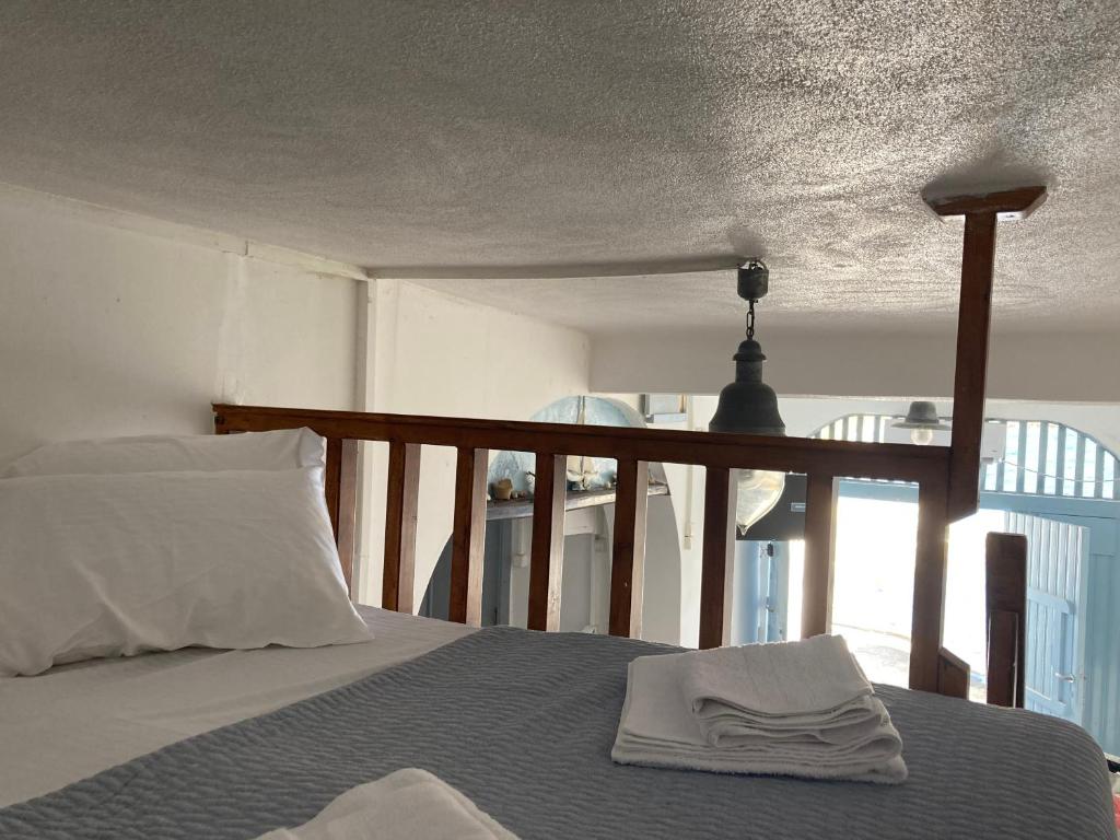 a bedroom with a bed with a towel on it at the monk seal boathouse in Klima